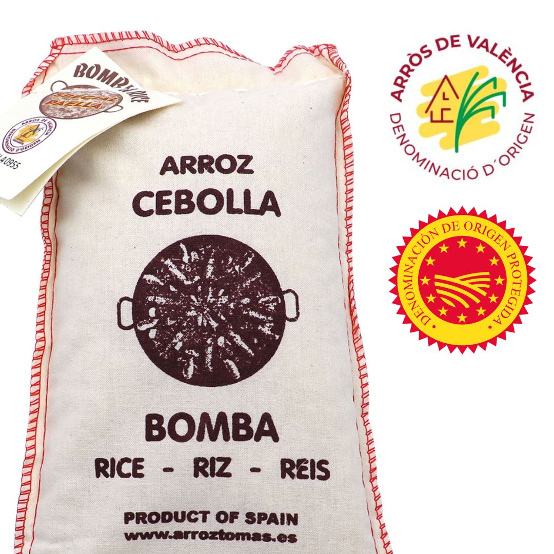 A rustic cloth sack of Arroz Cebolla Bomba rice proudly displays its Spanish origin. Stitched in red, the artisanal packaging features a central image of a paella pan, a nod to the rice’s prized use in traditional paella. Multilingual text—“RICE · RIZ · RÉIS”—underscores its global reach, while the D.O. seal on the attached tag confirms its high-quality regional pedigree.