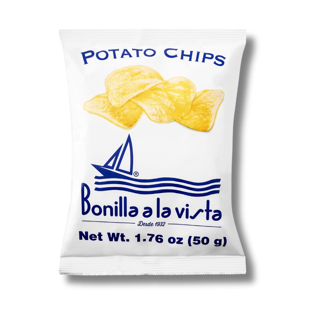A 50g bag of Bonilla a la Vista potato chips. The white packaging features a sailboat graphic, wave lines, and a trio of golden chips. Crisp, clean branding with a coastal flair.