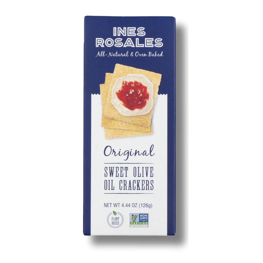 A box of Ines Rosales Original Sweet Olive Oil Crackers. The packaging is navy blue with a photo of square crackers topped with creamy cheese and red jam. Labeled as plant-based and non-GMO, these all-natural, oven-baked crackers come in a 4.44 oz (126g) box.
