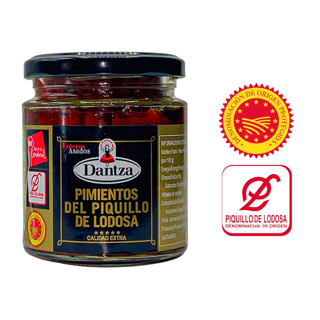 A close-up of Dantza’s roasted Piquillo peppers in a premium jar, featuring Denomination of Origin and quality seals. These authentic Spanish peppers from Lodosa are ideal for gourmet recipes, highlighting their certified origin and artisanal roasting.