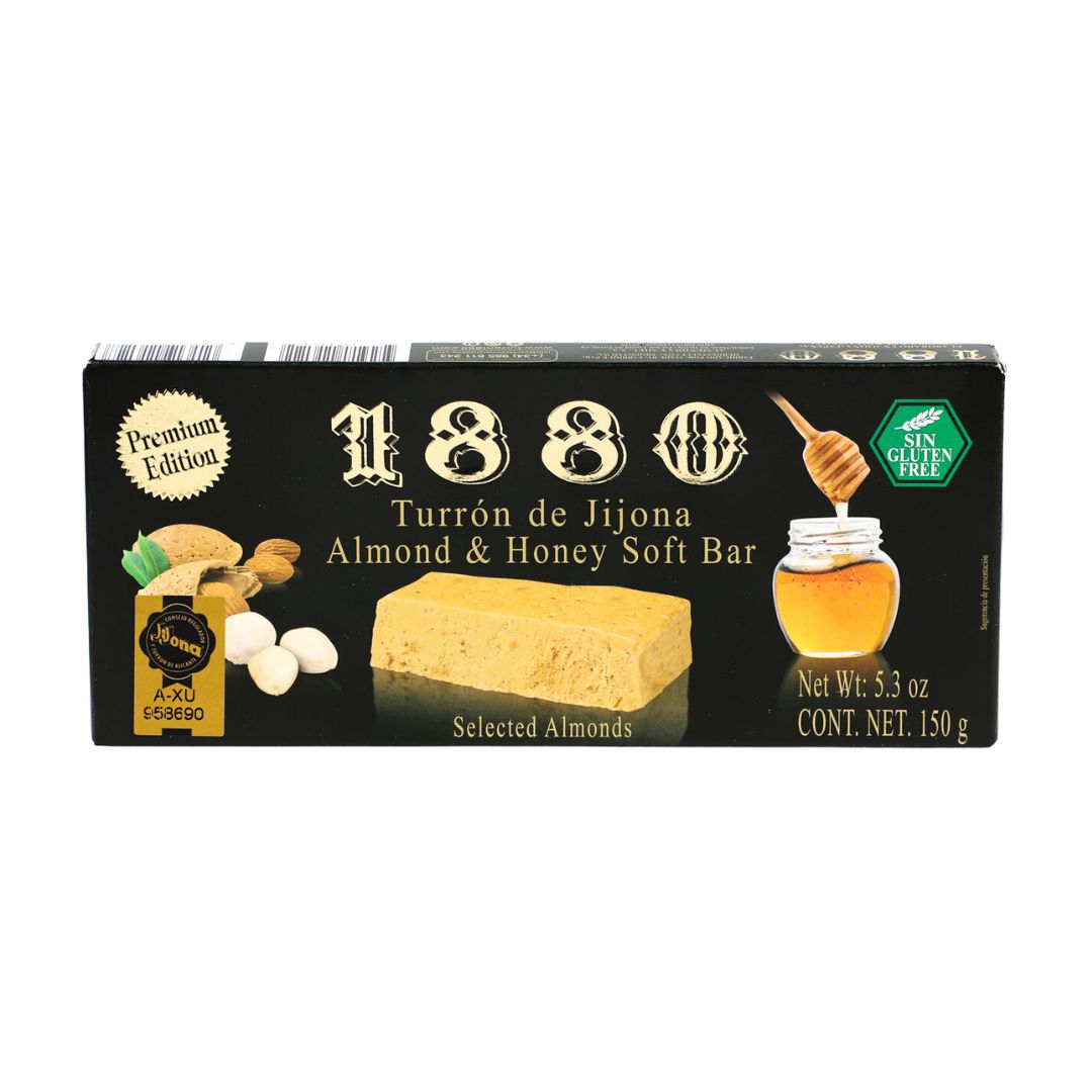 A sleek black box of 1880 Turrón de Jijona showcases a soft almond and honey nougat bar, highlighted by rich golden tones. Illustrations of a honey jar, almonds, and pistachios emphasize its natural ingredients, while bold vintage lettering and “Premium Edition” branding mark it as a traditional Spanish delicacy.