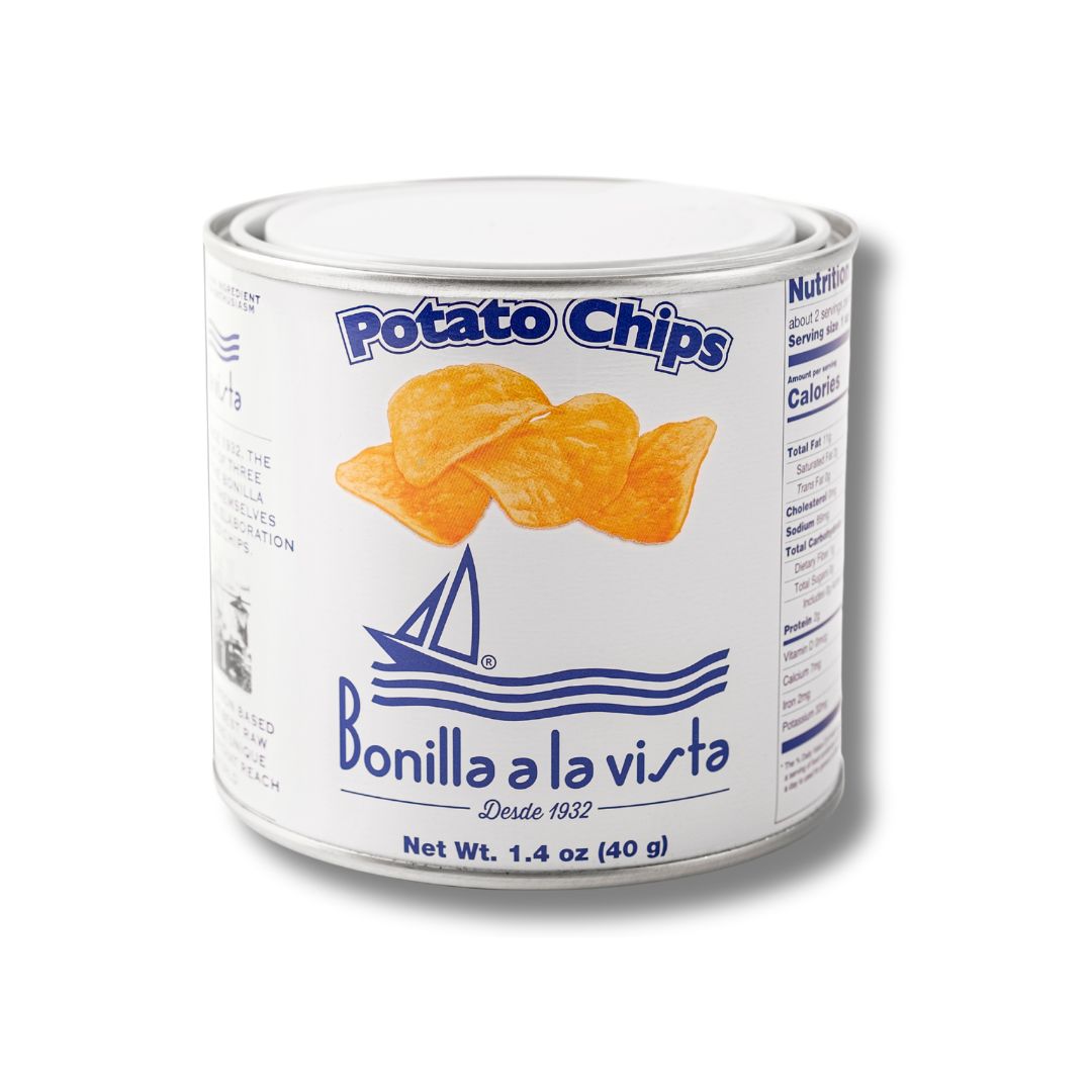 A 40g tin of Bonilla a la Vista potato chips. The compact white can features a sailboat graphic, bold blue lettering, and four golden chips. A crisp, travel-friendly version of the iconic Spanish snack.
