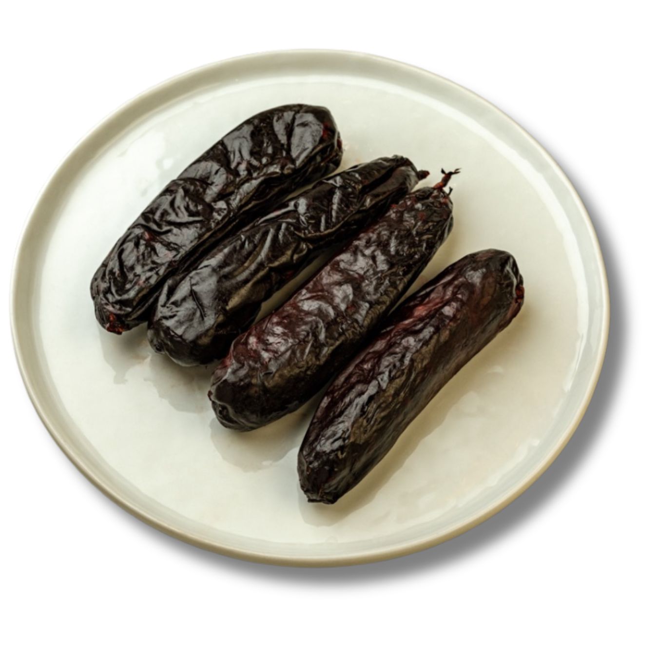 Four dark, glossy Morcilla sausages arranged on a plain white plate. Their rich, deep color and rustic casing.