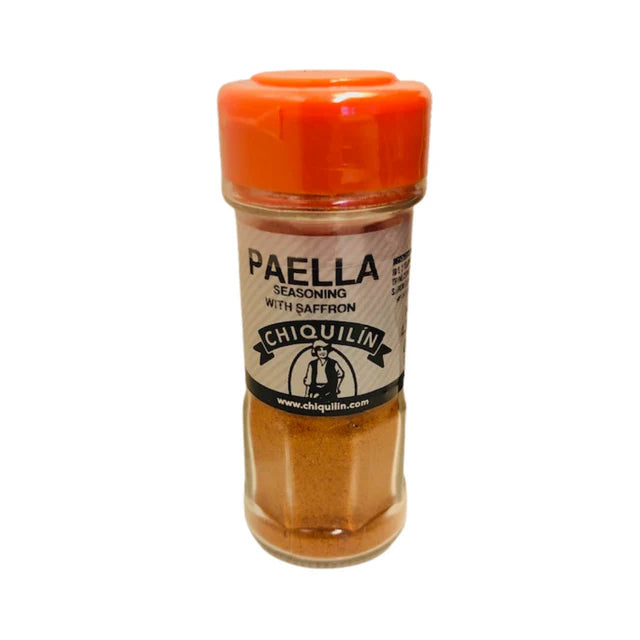 A clear spice jar of Chiquilín Paella Seasoning with saffron, featuring a bright orange lid and rustic label. The golden blend inside evokes authentic Spanish flavor, ideal for traditional paella dishes.