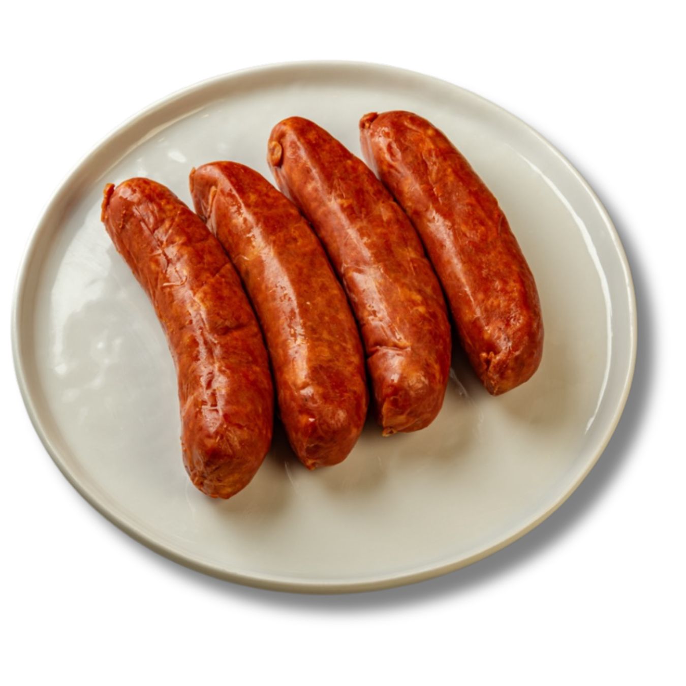Four plump Despana chorizo sausages rest on a white ceramic plate, showcasing their vibrant red color and smooth, cured texture. A classic example of traditional chorizo made with smoky Pimentón de la Vera. Ideal for tapas or grilling.