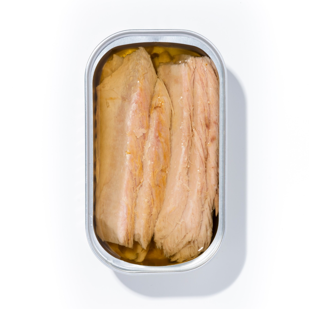 The Luliña tin opens to reveal thick, glistening fillets of yellowfin tuna belly nestled in golden olive oil.