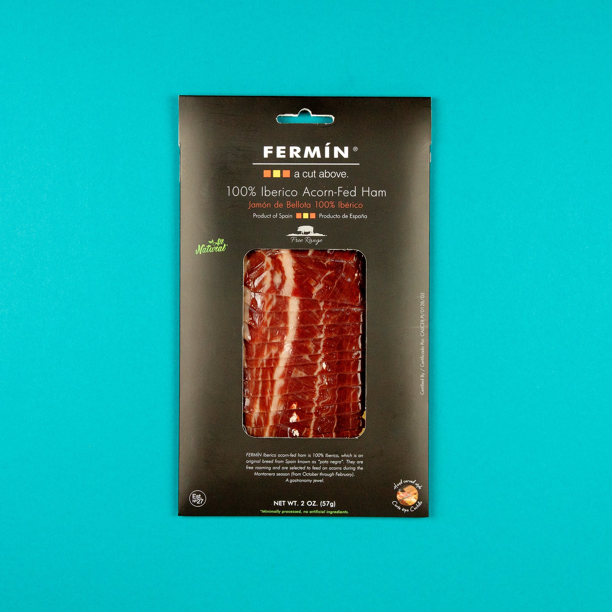 A 2 oz pack of Fermín 100% Ibérico Acorn-Fed Ham, elegantly boxed in black with a clear window showcasing the marbled slices. Labeled free-range and product of Spain—premium Jamón de Bellota at its finest.