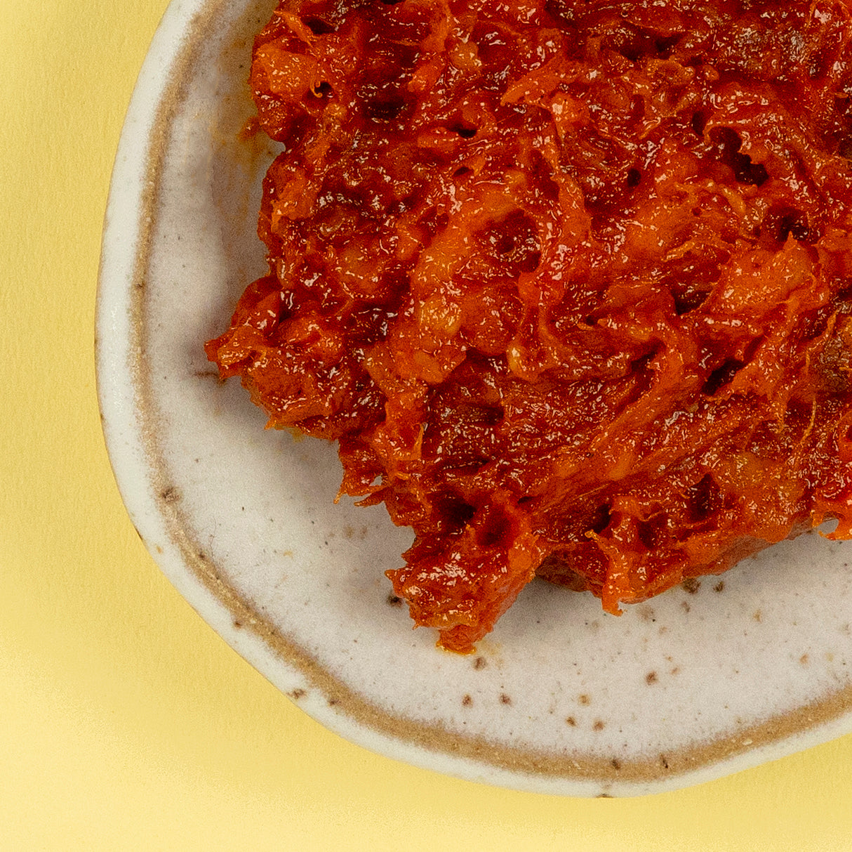 A close-up of FERMÍN's Sobrasada Ibérica reveals its rich, spreadable texture—deep red and flecked with glistening fat. This Spanish delicacy, seasoned with smoky paprika is perfect for rustic toast or bold tapas.