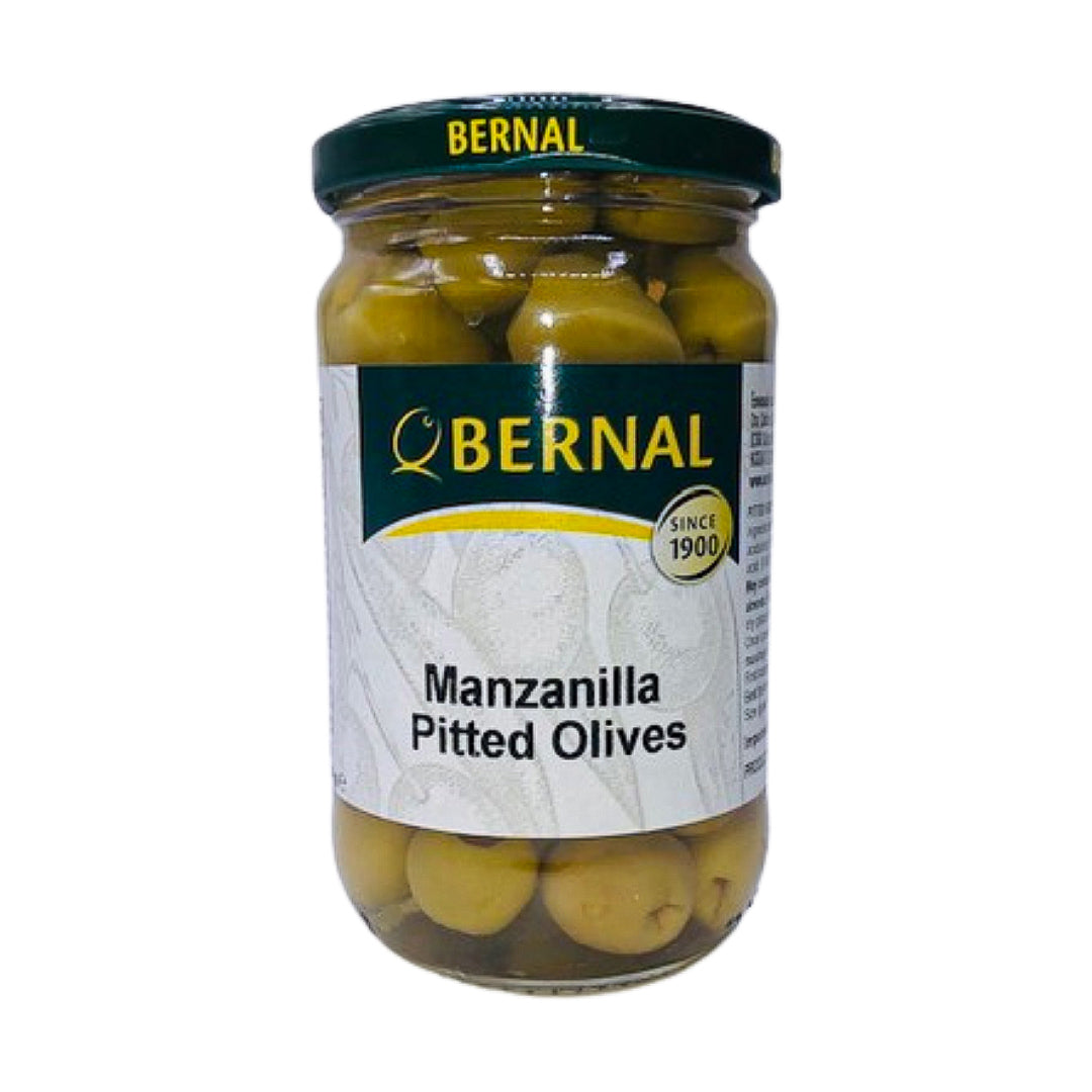 A clear jar of Bernal Manzanilla Pitted Olives showcases plump, green olives in brine. The classic label, marked "Since 1900," evokes tradition and quality in every bite.