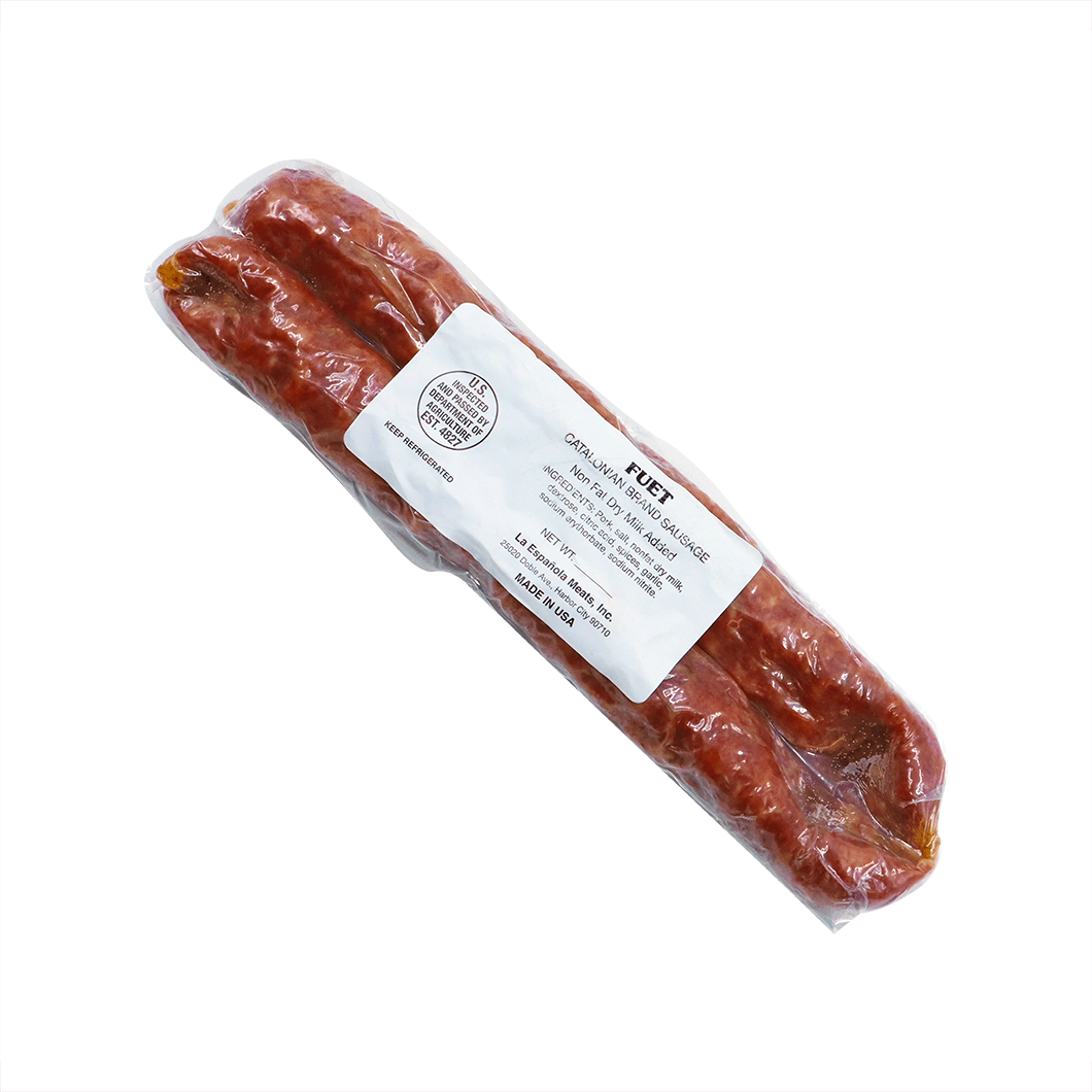 A vacuum-sealed package containing two links of Fuet, a Catalan dry Spanish sausage. The packaging is transparent, showcasing the reddish-brown cured sausages inside. A white label on the front includes information such as "Fuet," "Catalan Dry Spanish Sausage," "Keep Refrigerated," "Made in USA," and the producer's details, La Española Meats, Inc. The USDA inspection mark is also visible on the label.