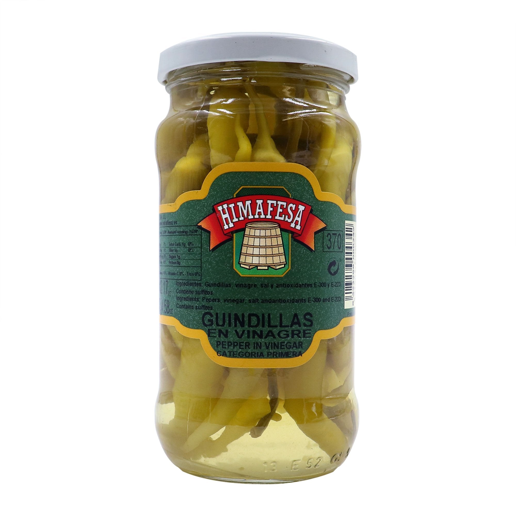 A clear jar of Himafesa guindilla peppers preserved in vinegar, showcasing premium whole green chili peppers. These Spanish-style pickled peppers add a tangy, mildly spicy kick to tapas, charcuterie boards, and Mediterranean recipes.