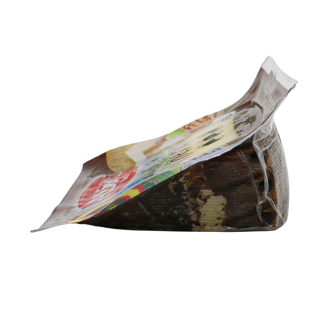 A side facing image of a pre-packed wedge of ibérico cheese from Spain.