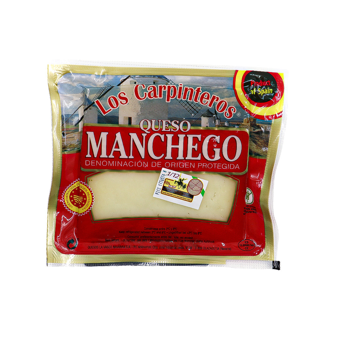 A vacuum-sealed wedge of Los Carpinteros Manchego cheese showcases its pale ivory interior and firm texture. Labeled with Denominación de Origen Protegida, this Spanish sheep’s milk cheese promises authenticity and rich, nutty flavor.