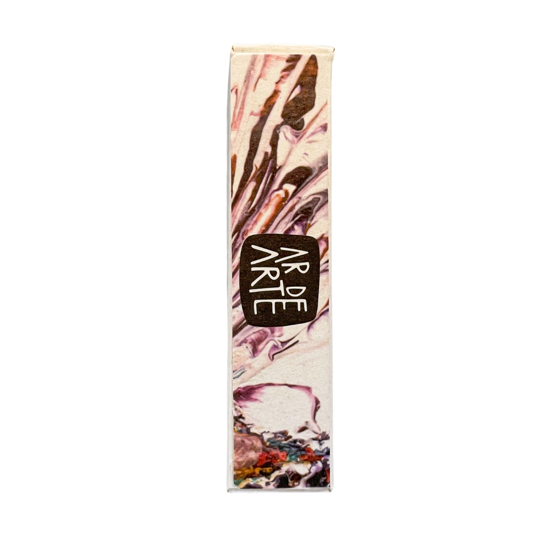 Side view of the product box with artistic, watercolor-style imagery of a scallop shell and colorful sea elements. The vertical label reads "AR DE ARTE" in white, hand-drawn-style font on a dark background. The design continues from the front, emphasizing a natural and artisanal aesthetic.