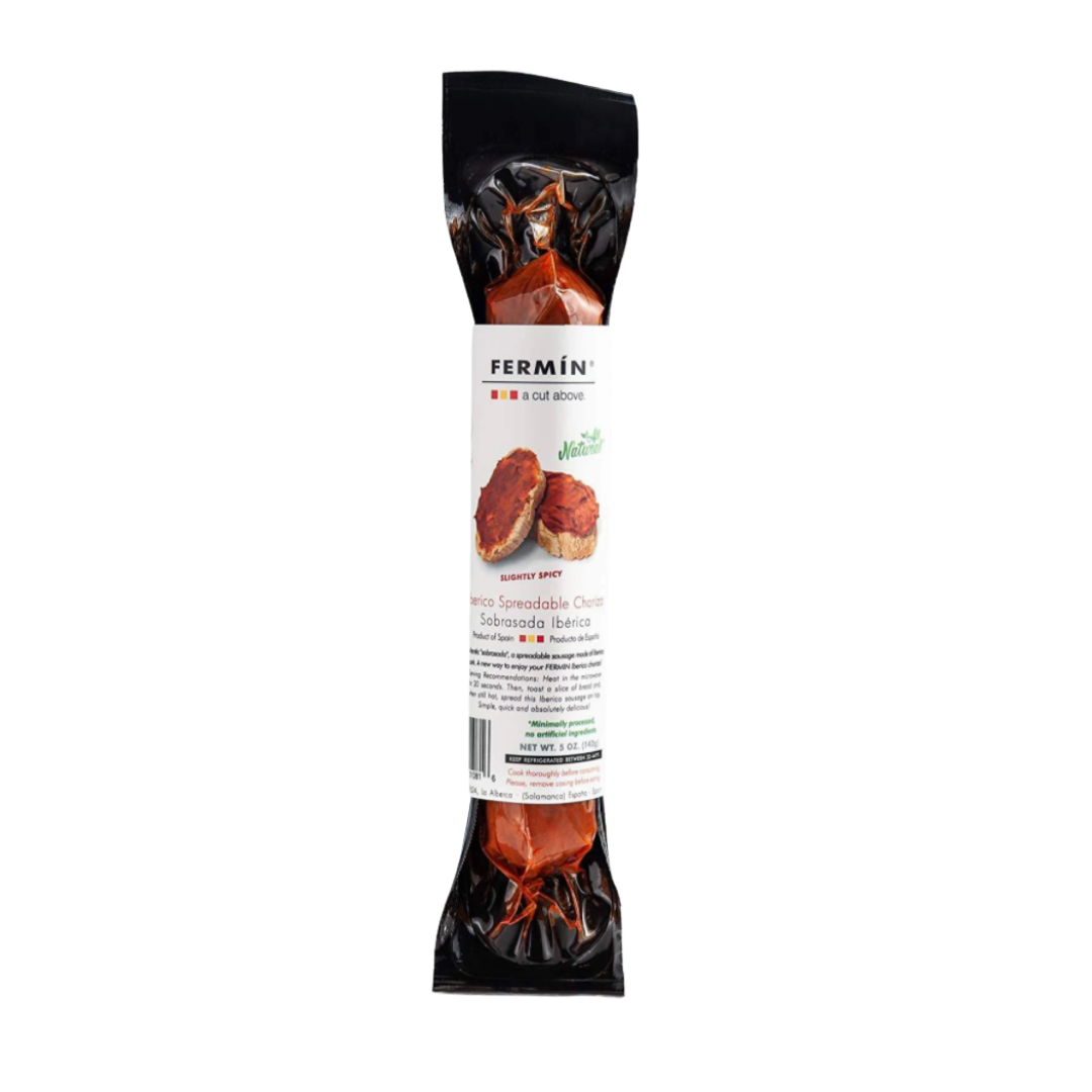 Encased in sleek vacuum-sealed packaging, FERMÍN's Ibérico Spreadable Chorizo stands out with its deep red hue and rustic label. A photo of toasts topped with the spicy, savory spread hints at its rich, smoky flavor—crafted in Spain, all-natural, and ready to elevate any bite.