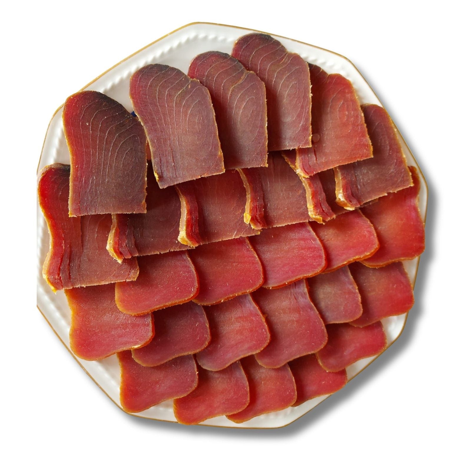 Platter of mojama (dry-cured red tuna loin) on a white background with 'MOJAMA' text.