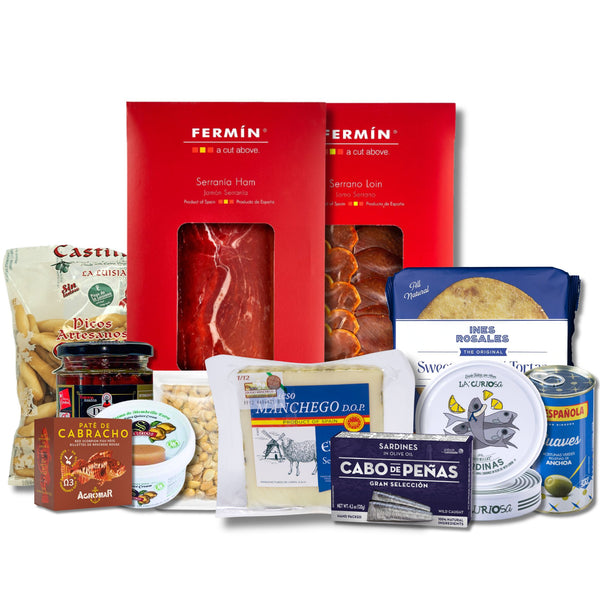A gift hamper of Spanish food products arranged together on a white background, including Fermin serrano ham in red packaging, Castilleca cheese, Cabachero jam, Sardinones, and other packaged snacks.
